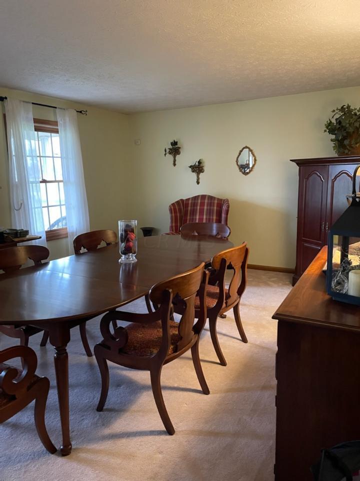 7680 Degood Road Ostrander, OH 43061 - Photo 11 of 42 14'0 x 18'9 Formal dining room with beige carpeting.