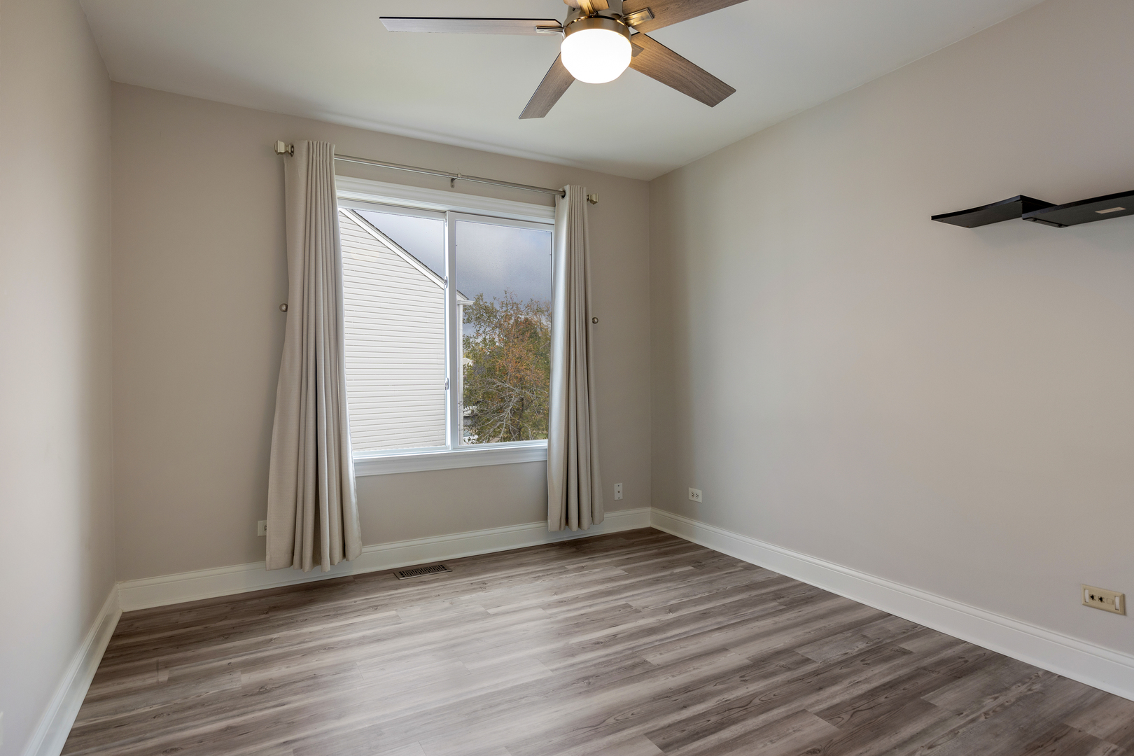 1032 Willow Bay Elgin, IL 60123 - Photo 14 of 27 an empty room with wooden floor and windows