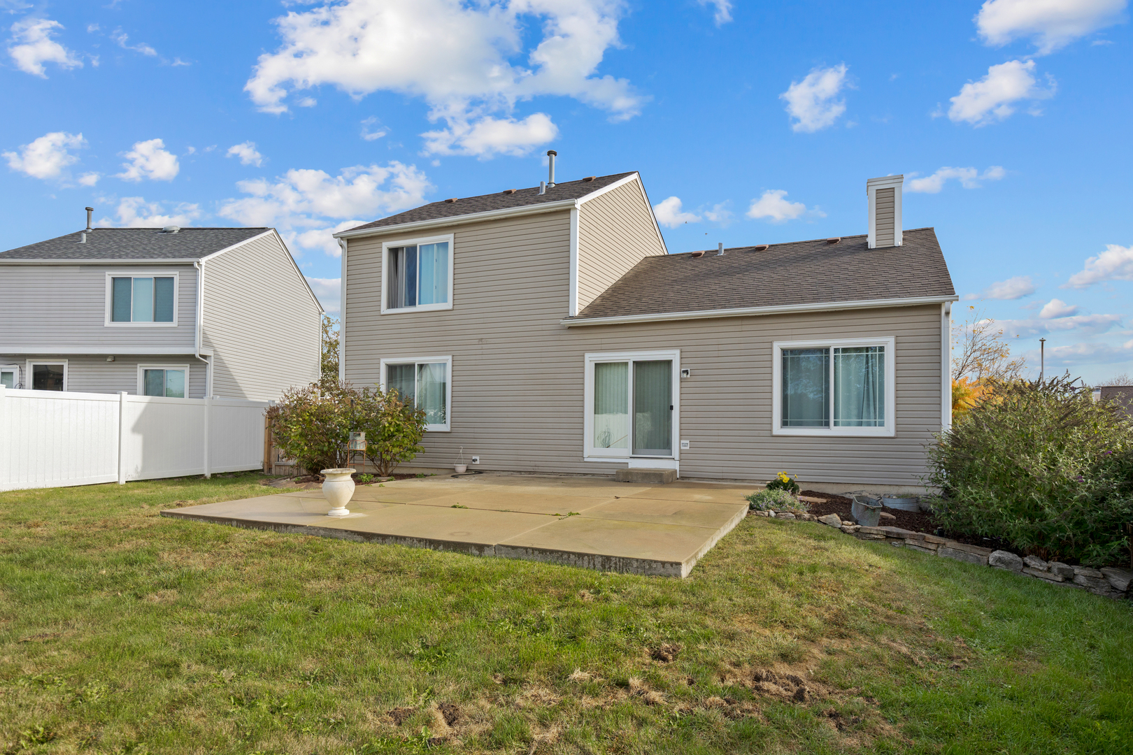 1032 Willow Bay Elgin, IL 60123 - Photo 22 of 27 a view of a house with a yard and potted plants