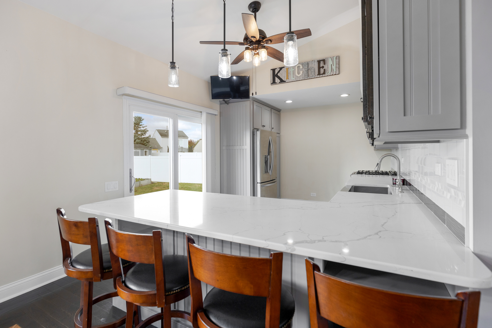 1032 Willow Bay Elgin, IL 60123 - Photo 8 of 27 a dinning room with stainless steel appliances kitchen island a table chairs and a refrigerator