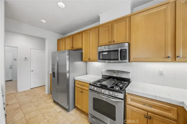 a kitchen with stainless steel appliances a refrigerator sink and cabinets
