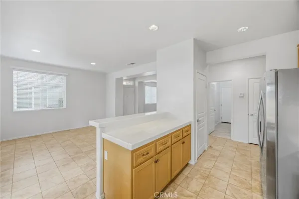 a kitchen with a refrigerator and a stove