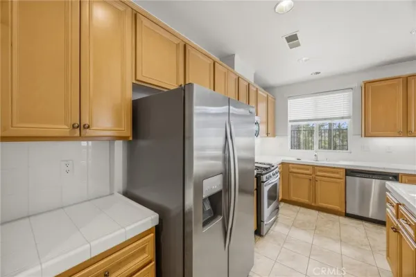an empty room with a window and a ceiling fan