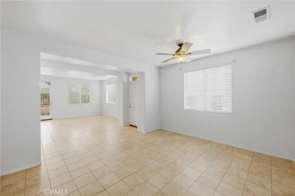 an empty room with windows and closet