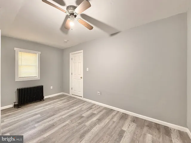 a view of a livingroom with a ceiling fan and window