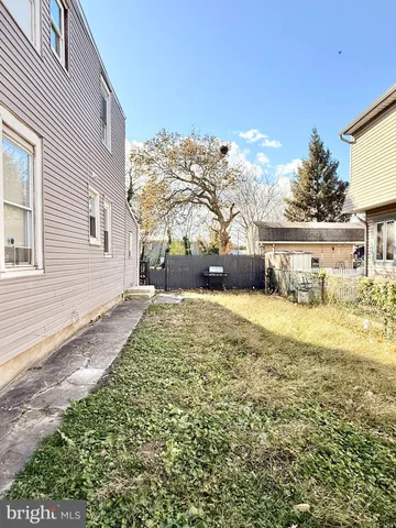a view of a yard with a large tree