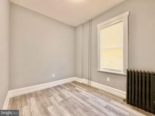a view of a room with wooden floor and cabinet