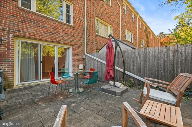 a view of an outdoor sitting area with wooden fence