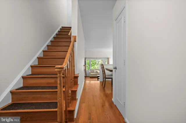 a view of entryway and hall with wooden floor