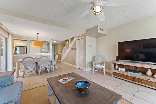 a living room with furniture and a chandelier