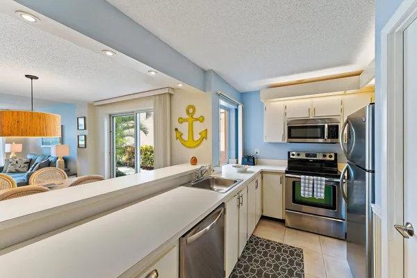 a kitchen with a sink and a stove top oven