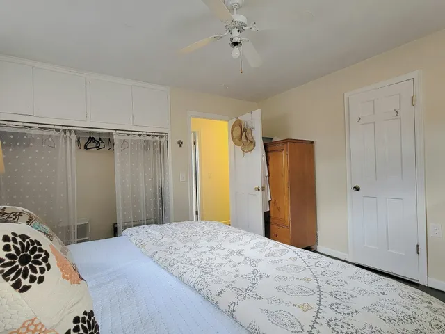 a bedroom with a bed and a dresser