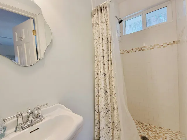 a bathroom with a shower curtain and a sink