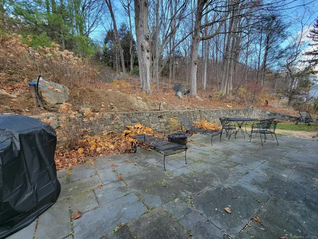 a view of a backyard with table and chairs