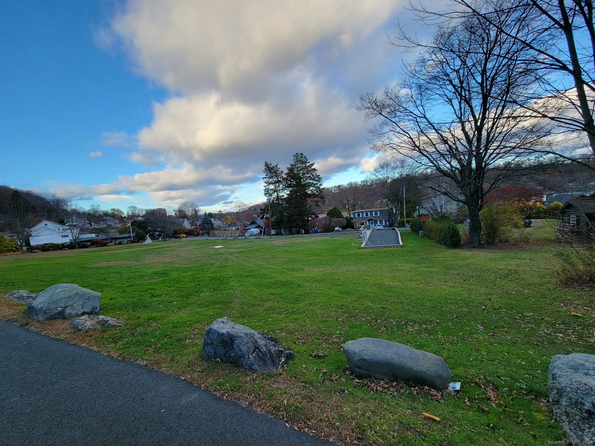 4 Candlewood Knolls Road New Fairfield, CT 06812 - Photo 19 of 21 a backyard of a house with table and chairs plants and large tree