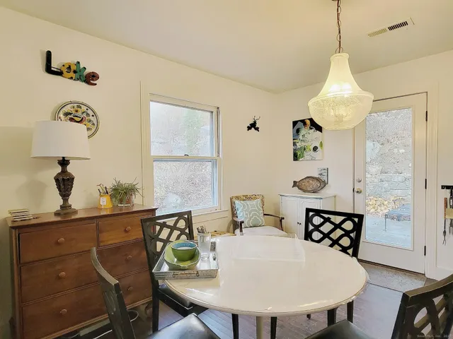 a view of a dining room with furniture and a window