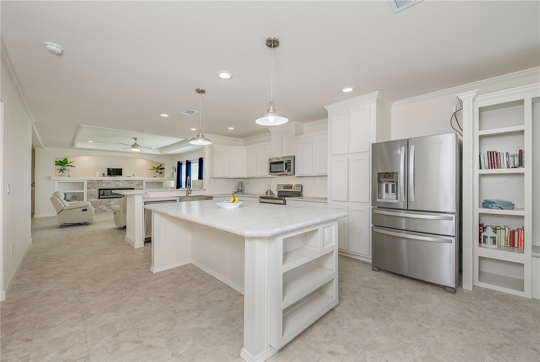 10976 Whiterock Road Bremond, TX 76629 - Photo 12 of 42 a kitchen with kitchen island a sink stainless steel appliances and cabinets