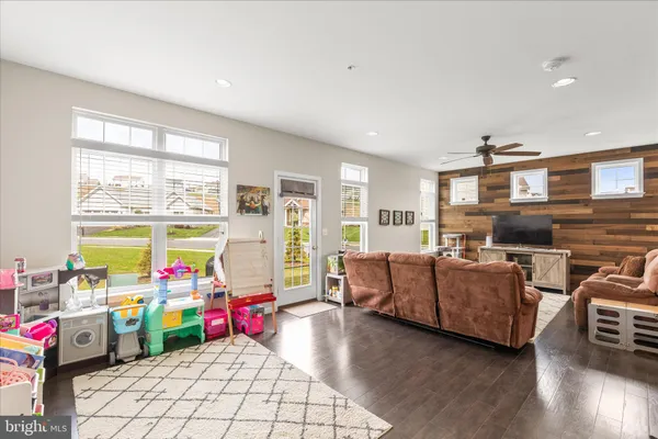 a living room with furniture and a floor to ceiling window