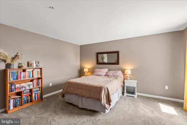 a bedroom with a bed and a book shelf