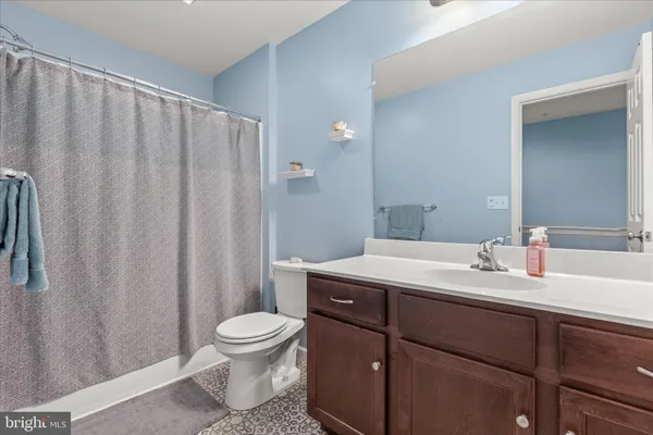 a bathroom with a toilet a sink and a mirror