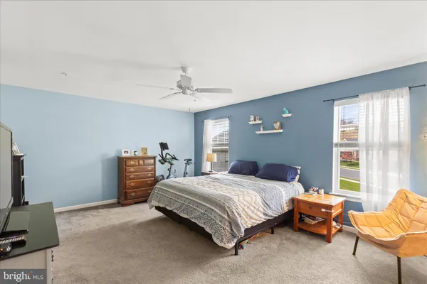 a bedroom with a bed and a couch