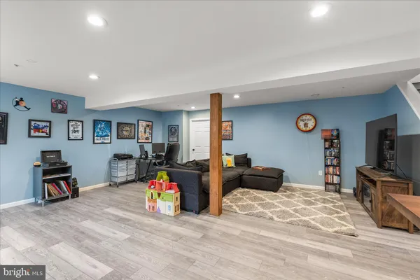a bedroom with furniture and a flat screen tv