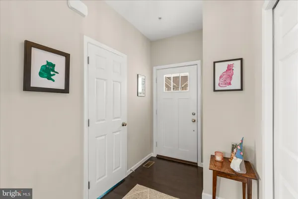 a view of room with hallway and wooden floor