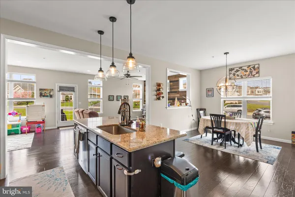 a open kitchen with stainless steel appliances granite countertop a stove and refrigerator