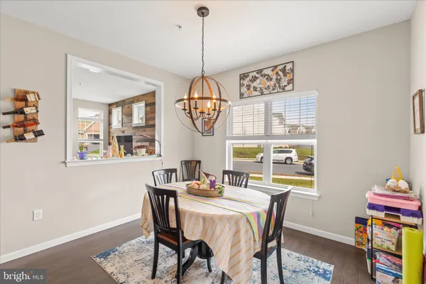 a dining room with furniture a rug and a window