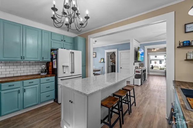 a kitchen with stainless steel appliances granite countertop a refrigerator and a sink