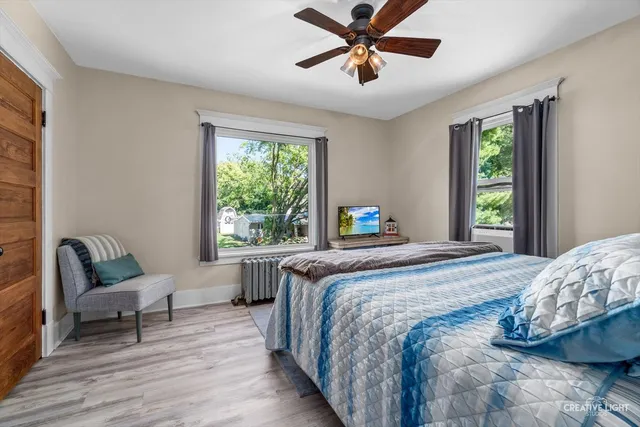 a bedroom with a bed a couch and a window