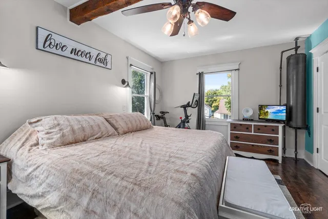 a bedroom with a bed and a chandelier