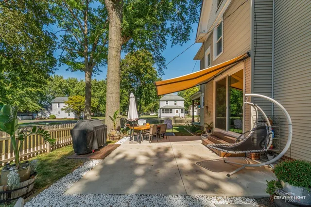 an outdoor sitting area with couch and lounge chair