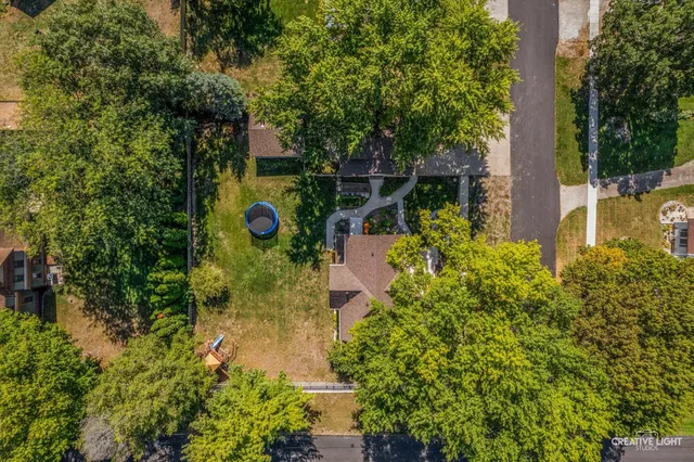 an aerial view of a house with a yard and lake view