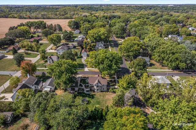an aerial view of a house with swimming pool and patio