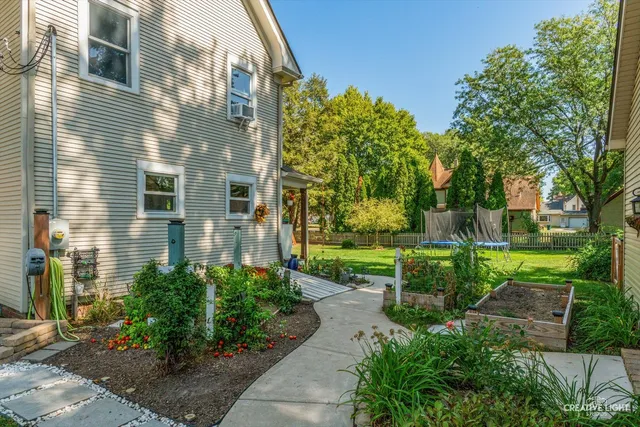 a view of a house with backyard and sitting area