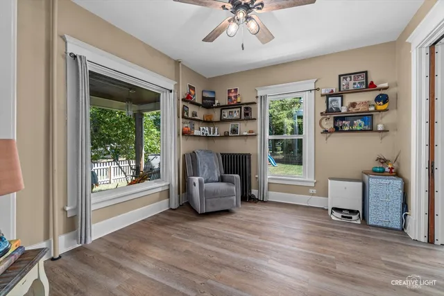 a view of an empty room with furniture and a window
