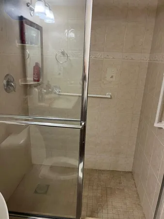 a bathroom with a glass shower door