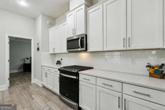 a bedroom with a bed a couch and a window