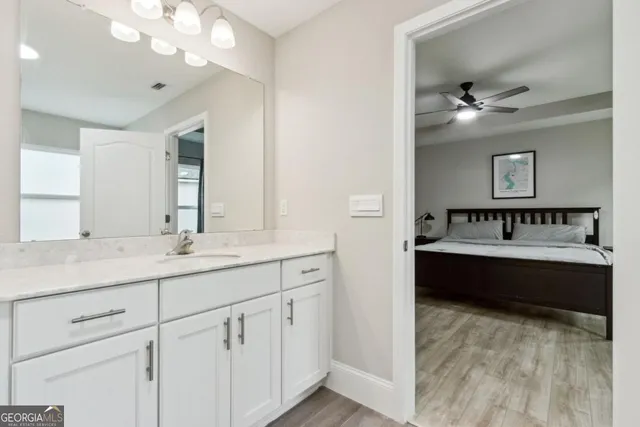 a bathroom with a sink vanity and a toilet