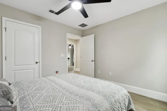 a sign that is on a brick wall with a tree