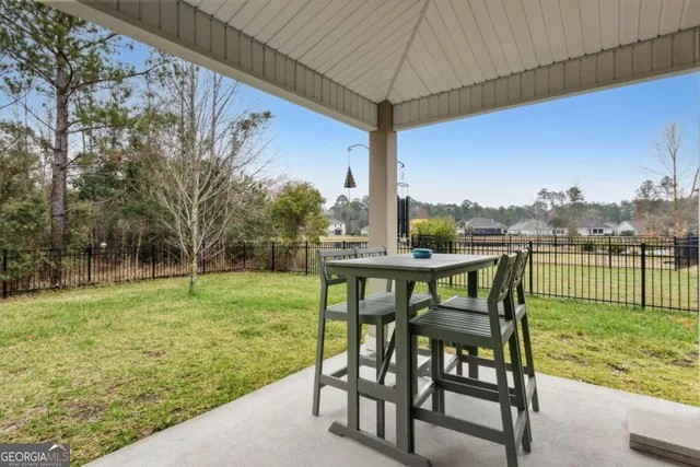 an aerial view of a house with yard and outdoor seating