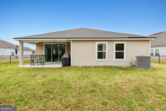 an aerial view of a house with garden space and street view