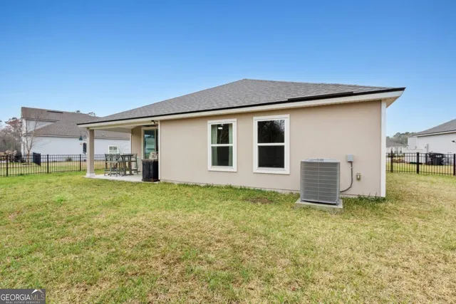 a view of a golf club with a backyard of the house