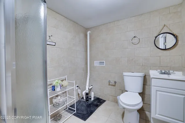 a bedroom with a bed and a flat tv screen on dresser