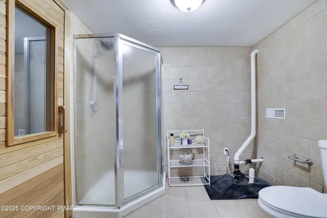 a bedroom with bed and wooden floor