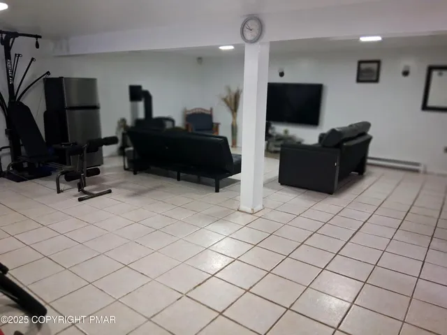 a living room with a fireplace a flat screen tv and a fireplace