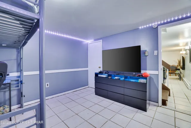 a view of a dining room with furniture a chandelier and wooden floor