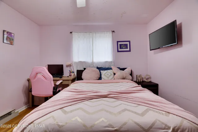 a front view of house with yard and trees in the background