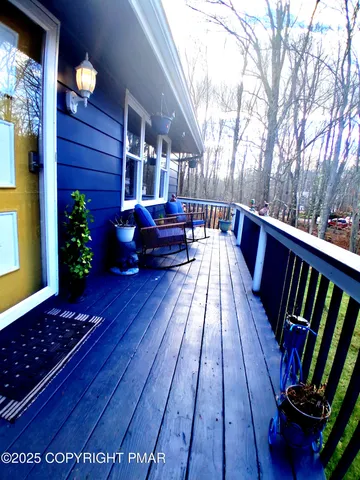 a view of balcony with chairs and wooden floor
